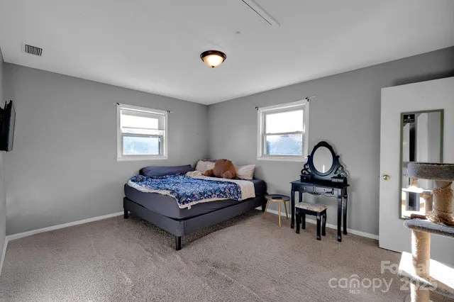 a bed room with furniture and a window