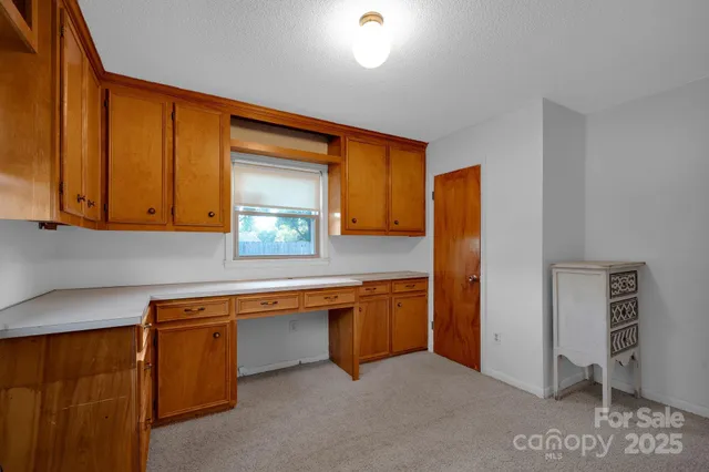 a kitchen with stainless steel appliances granite countertop a sink and a refrigerator