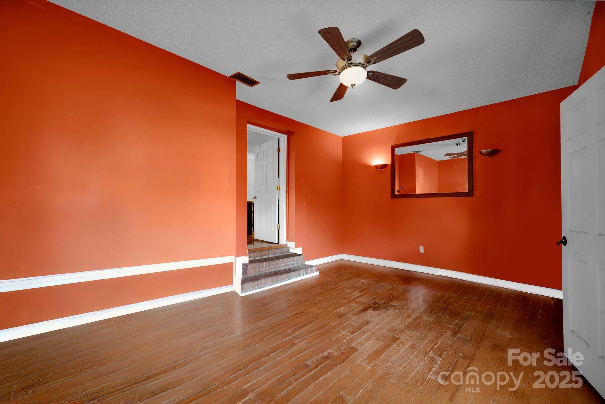 3168 Sossamon Place Concord, NC 28025 - Photo 19 of 37 an empty room with wooden floor and ceiling fan