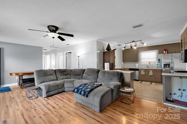 a living room with furniture and kitchen view