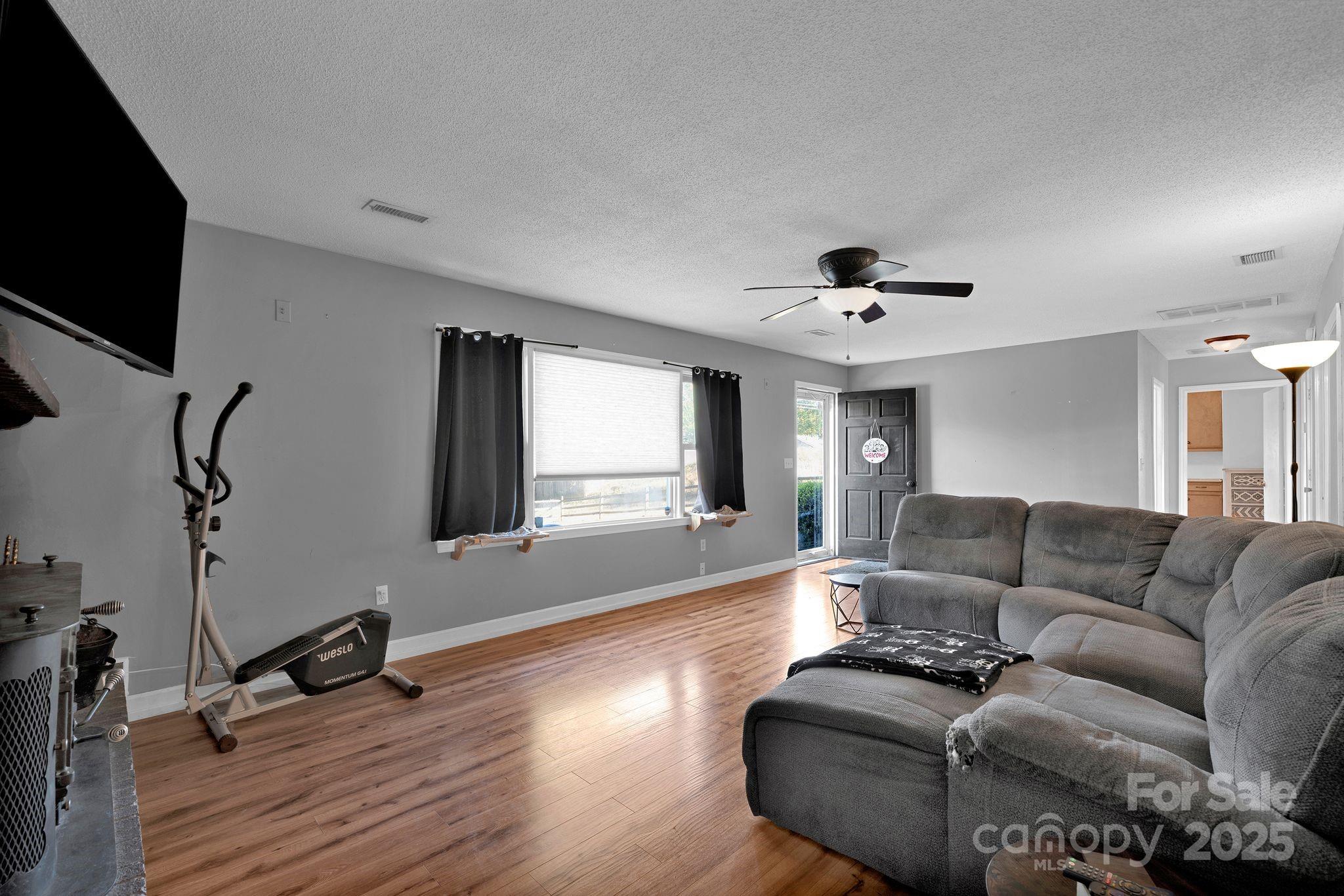 3168 Sossamon Place Concord, NC 28025 - Photo 6 of 37 a living room with furniture and a flat screen tv
