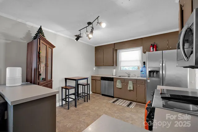 a kitchen with refrigerator cabinets and wooden floor
