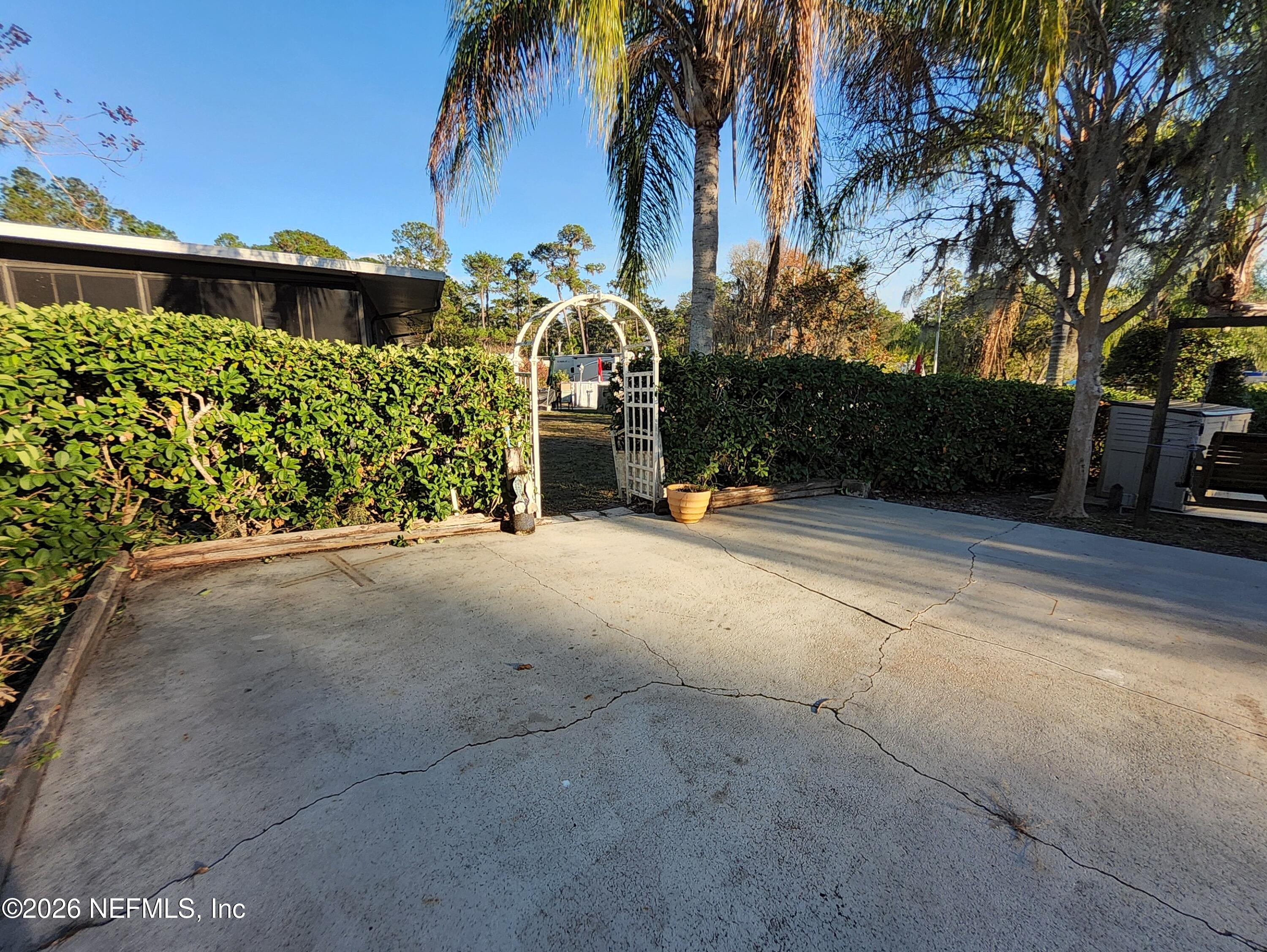 1074 Front Street, Unit 50B Welaka, FL 32193 - Photo 9 of 20 a view of a house with a yard and potted plants