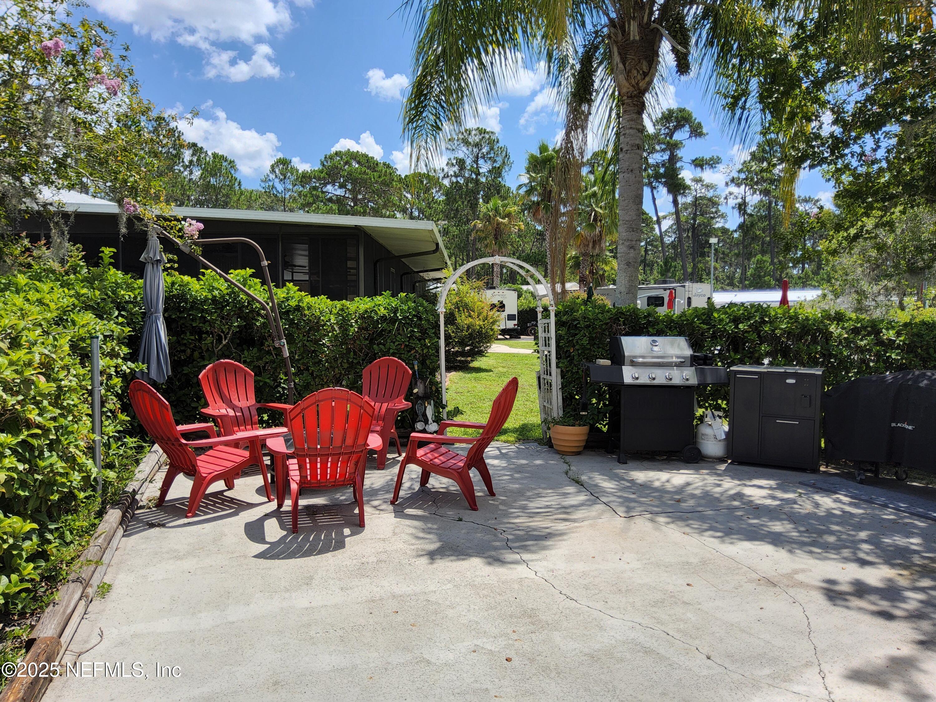 1074 Front Street, Unit 50B Welaka, FL 32193 - Photo 10 of 20 a view of a chairs and tables in the back yard of the house