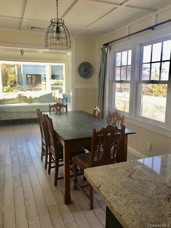 a view of a dining room with furniture and window