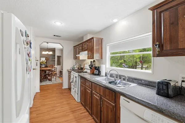 a kitchen with sink a window and stainless steel appliances