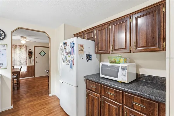 a kitchen with stainless steel appliances granite countertop a refrigerator and microwave