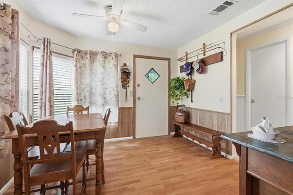 a view of a dining room with furniture and a window