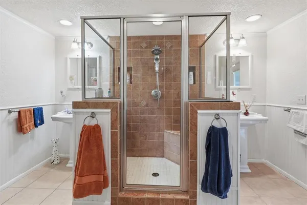 a bathroom with a shower a mirror and a shower
