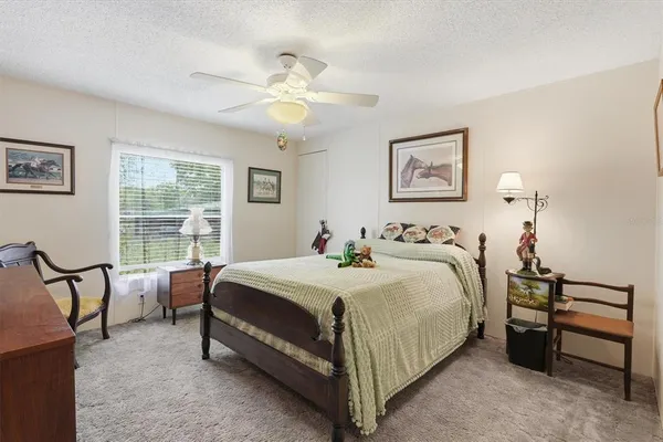 a bed room with a bed and a chair