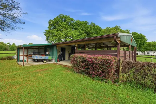 a view of a house with backyard porch and sitting area