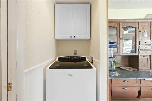 a kitchen with granite countertop white cabinets and a stove