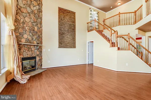 a dining room with furniture a chandelier and wooden floor