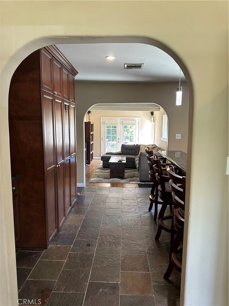 4910 Willowcrest Avenue Toluca Lake, CA 91601 - Photo 12 of 25 a living room with furniture a large mirror and a glass door
