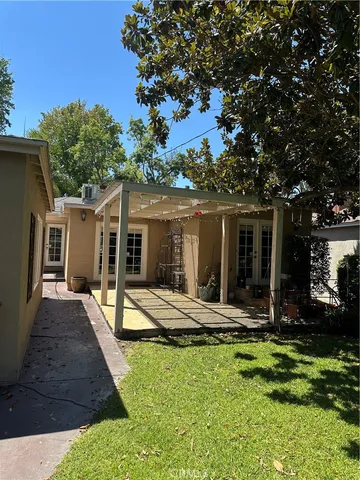a view of a house with backyard porch and sitting area
