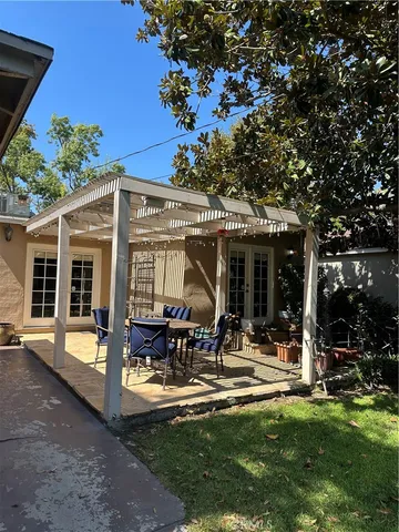 a view of a house with backyard porch and sitting area