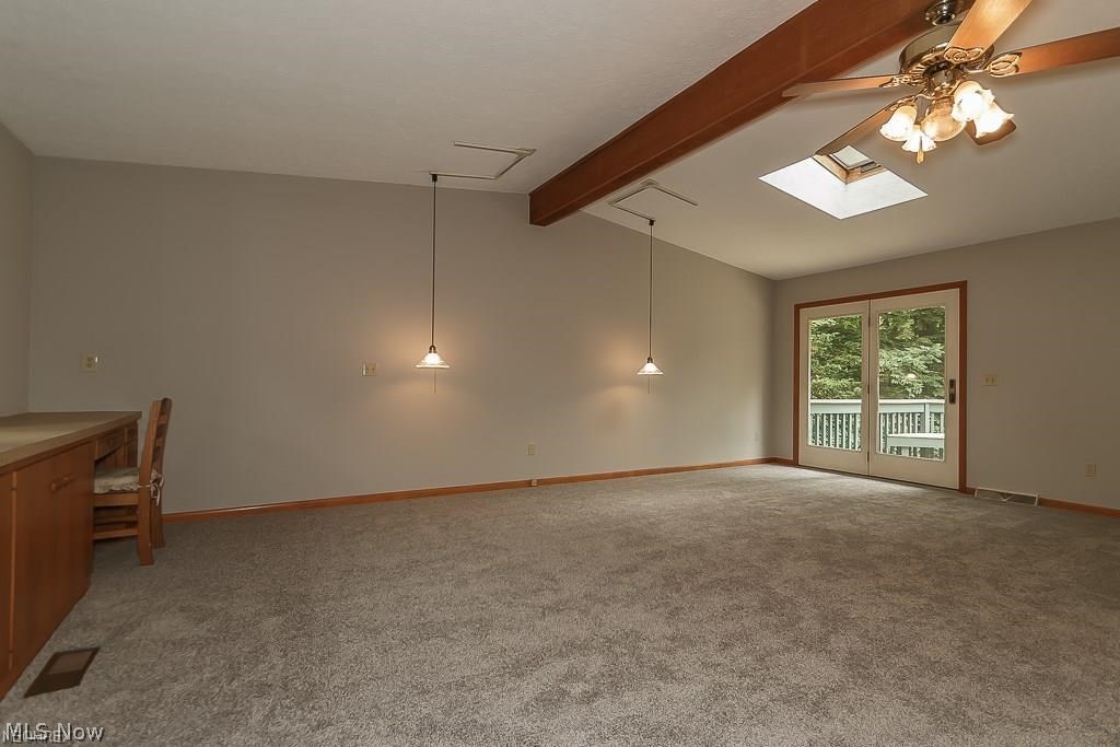 9979 Wilson Mills Road Chardon, OH 44024 - Photo 13 of 35 Expansive First Floor Beamed Master Bedroom with Built in Desk, Pull Out Drawers, Patio Doors to the Deck and Newer Carpeting!