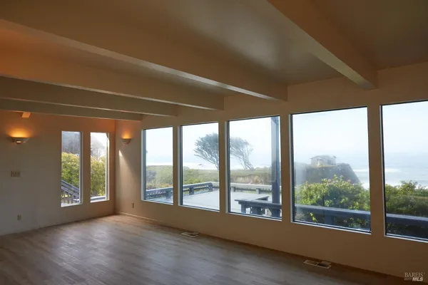 a bedroom with a large bed and a large window