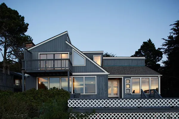 an empty room with sliding glass door and mountain view