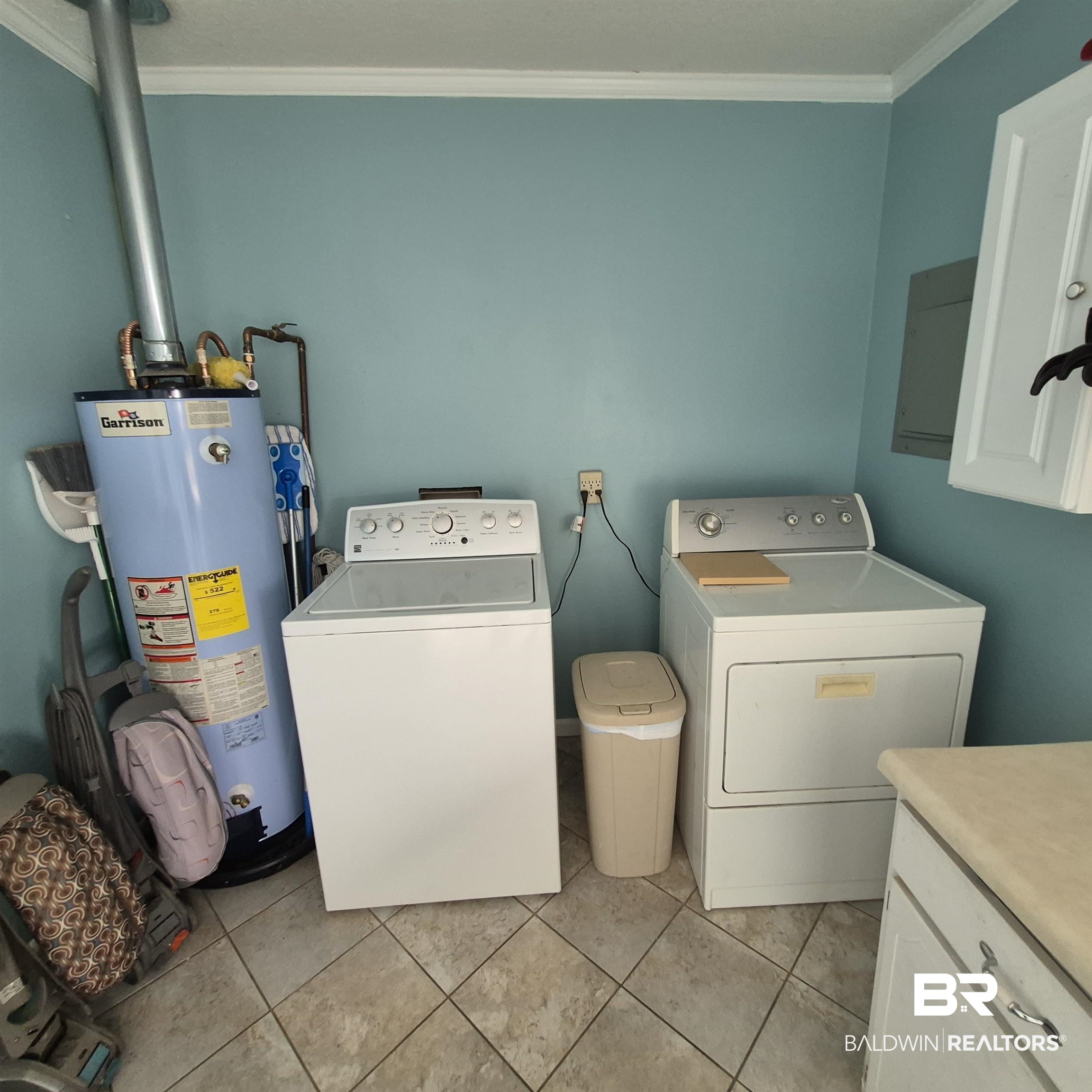 26635 Highway 41 Range, AL 36473 - Photo 35 of 74 Laundry area with crown molding, gas water heater, independent washer and dryer, electric panel, and light tile patterned floors