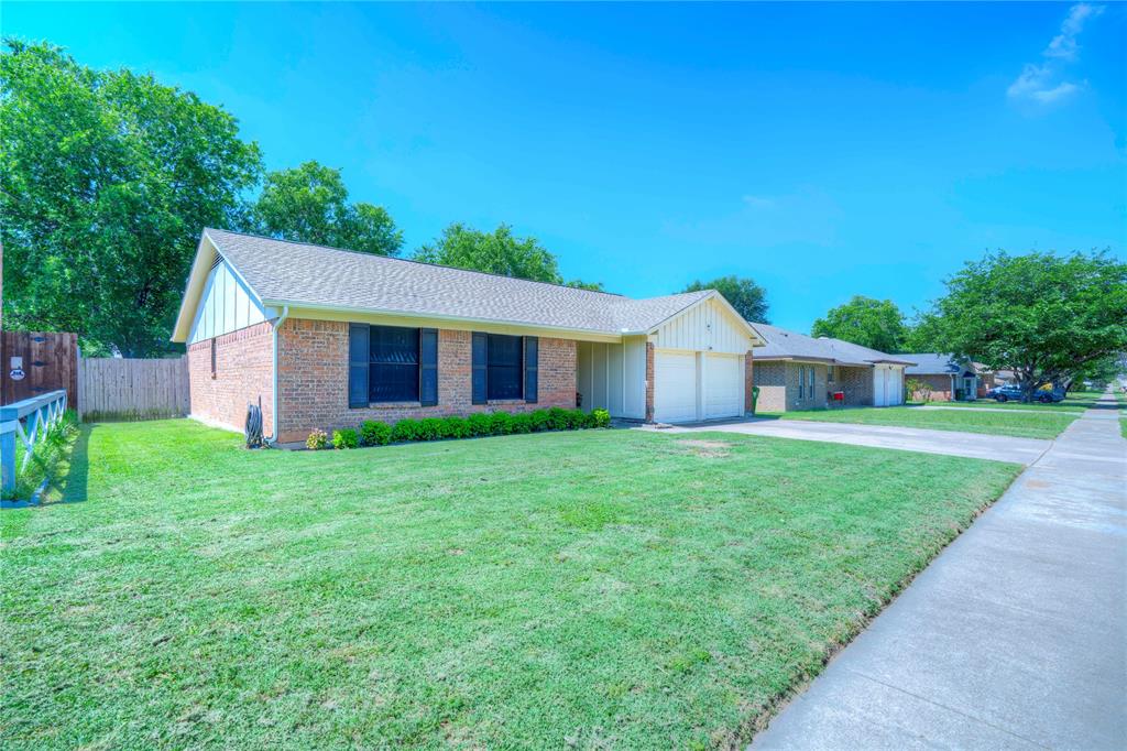 6028 Ridgecrest Drive Watauga, TX 76148 - Photo 2 of 40 a front view of a house with yard and green space