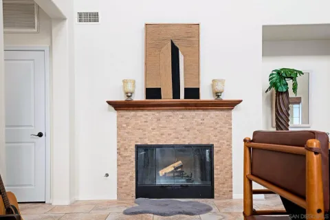 a kitchen with stainless steel appliances granite countertop a sink a stove and a dining table with chairs