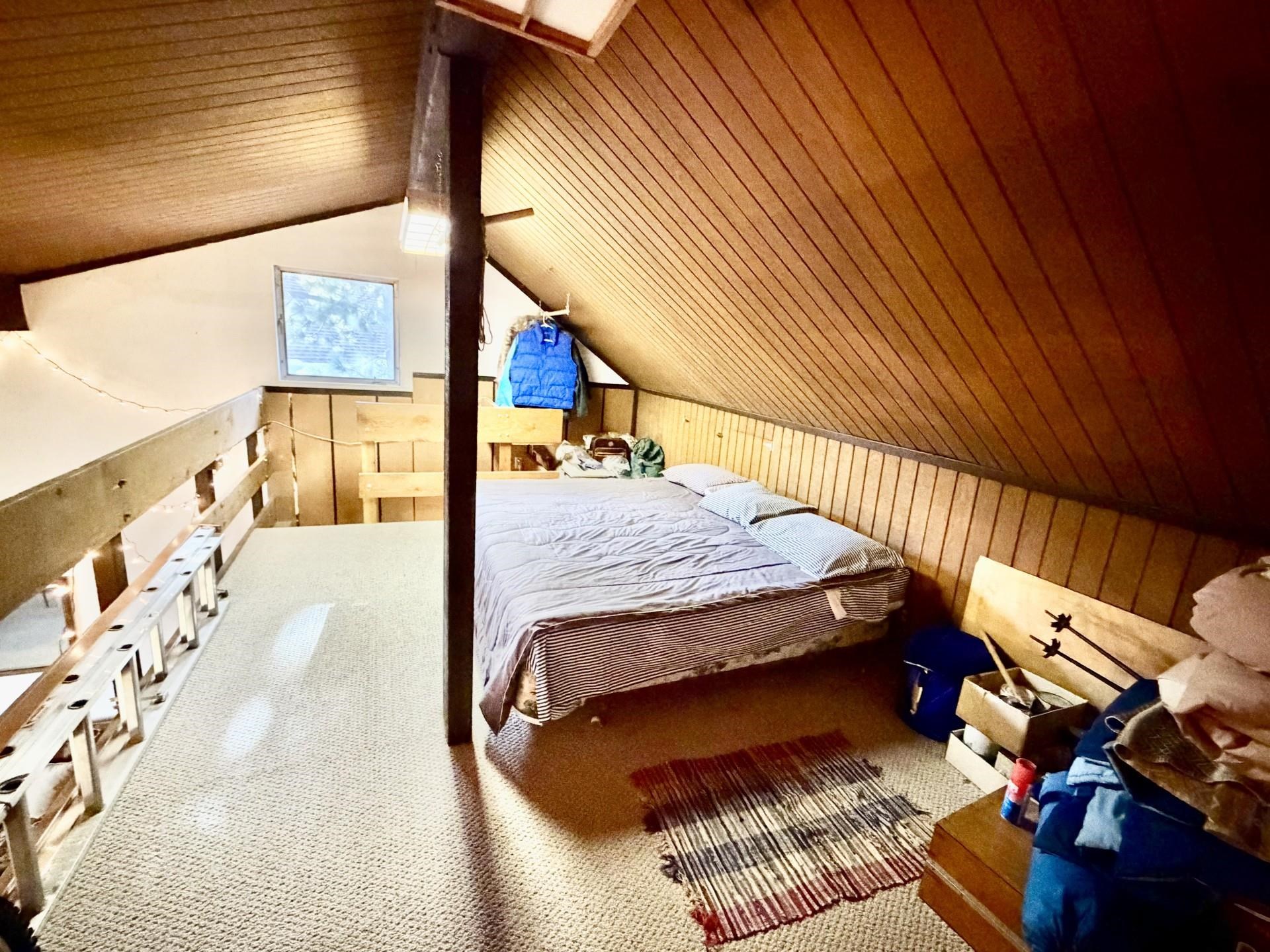 165 Old Mammoth Road, Unit 105 Mammoth Lakes, CA 93546 - Photo 13 of 17 a bedroom with a bed and wooden floor