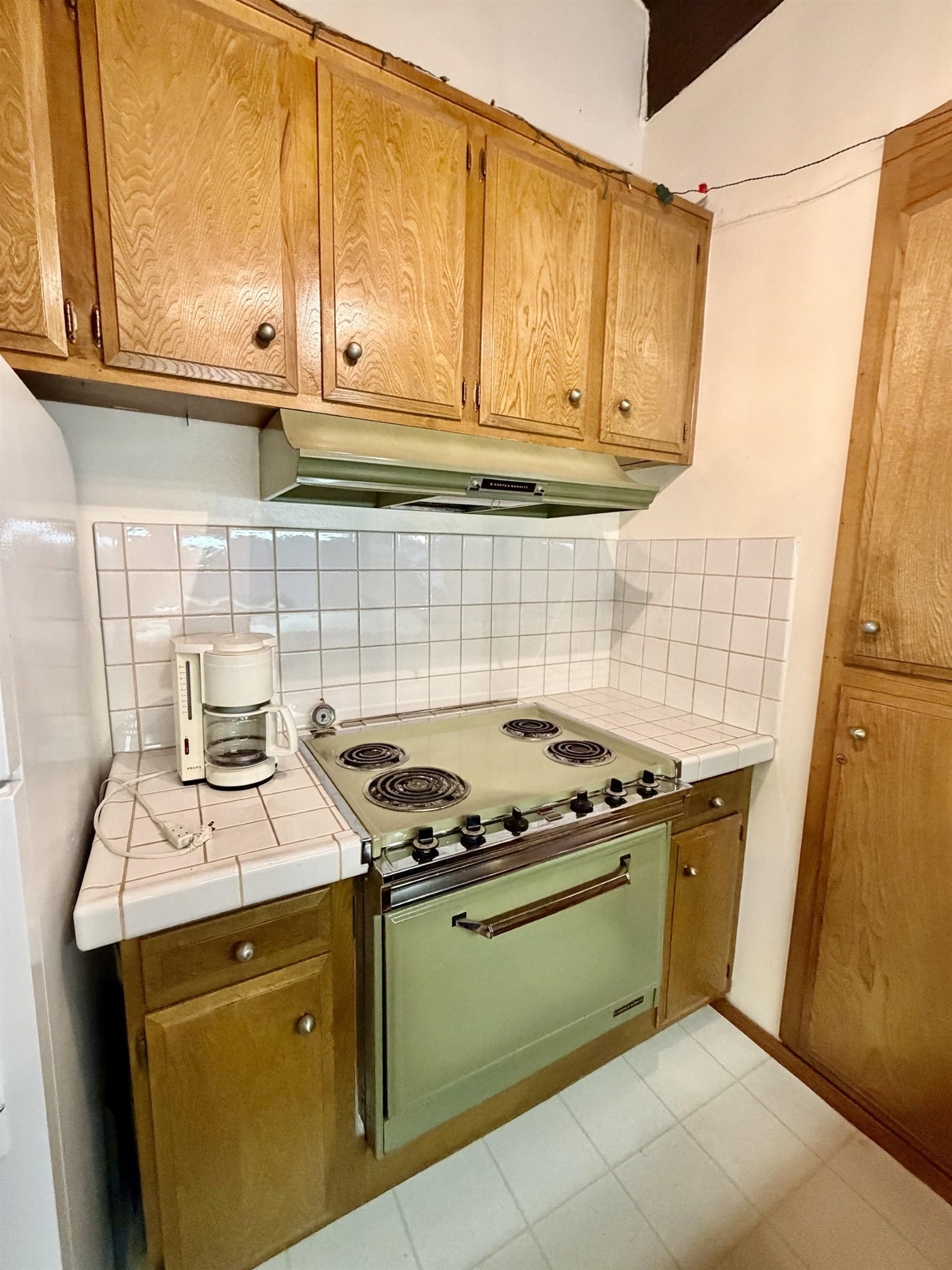165 Old Mammoth Road, Unit 105 Mammoth Lakes, CA 93546 - Photo 16 of 17 a kitchen with a stove and a microwave