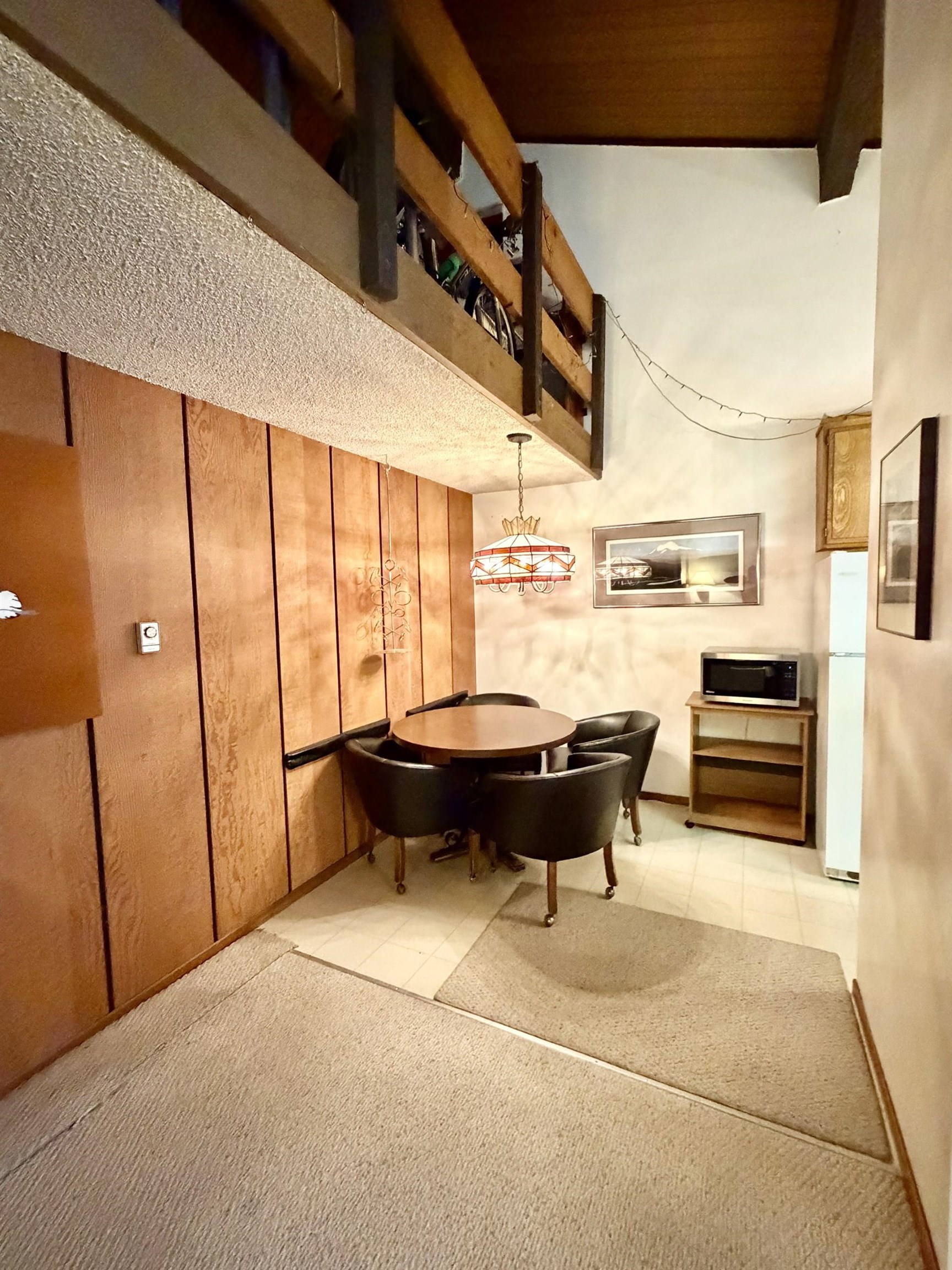 165 Old Mammoth Road, Unit 105 Mammoth Lakes, CA 93546 - Photo 7 of 17 a living room with furniture a ceiling fan and a large window
