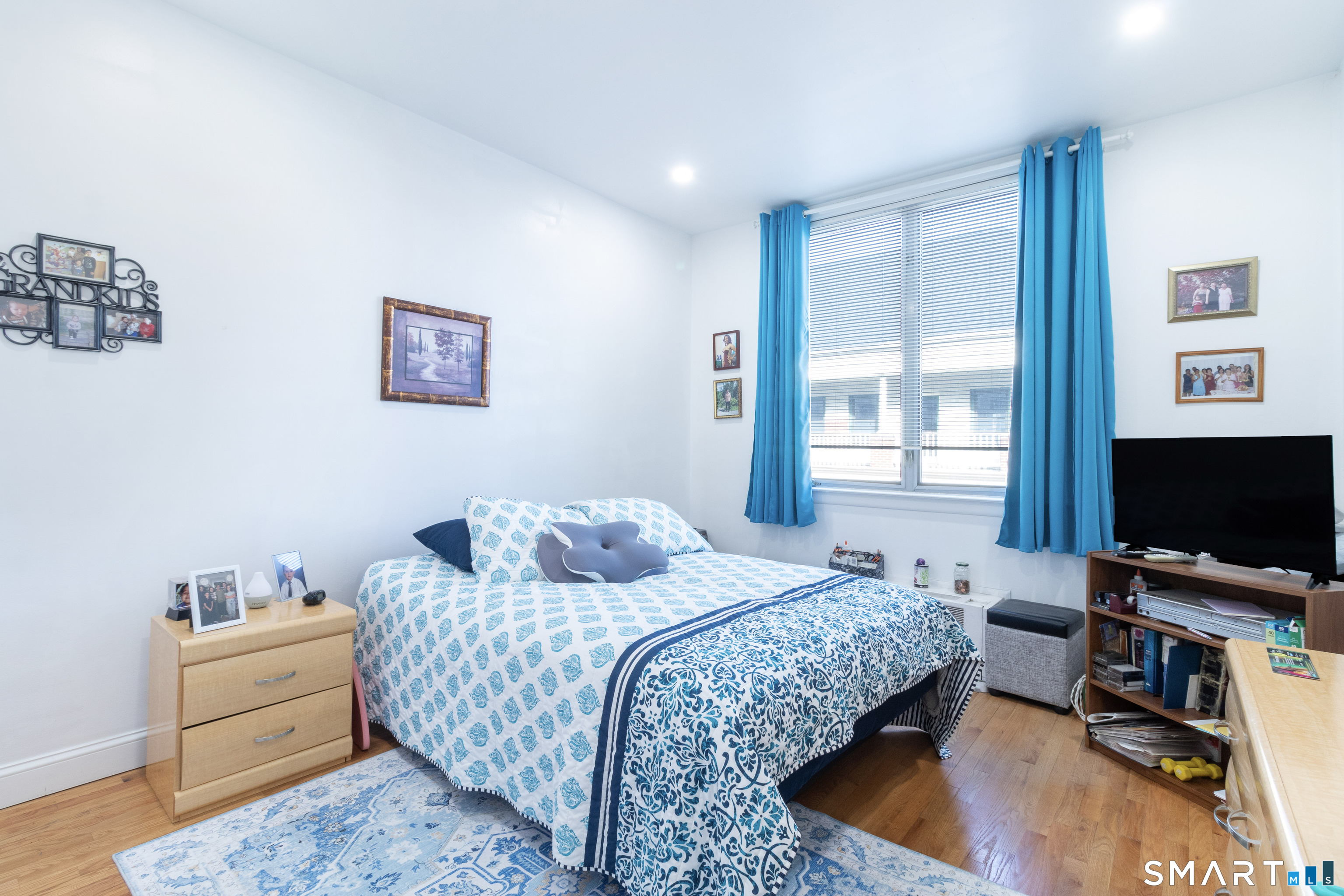 49 Day Street, Unit 209 Norwalk, CT 06854 - Photo 12 of 20 a bedroom with a bed and a flat screen tv