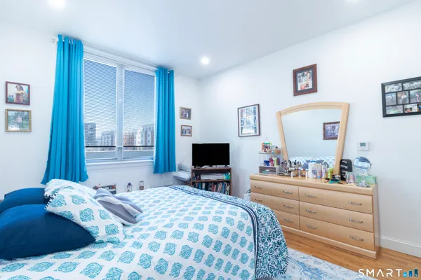 a bedroom with a bed and a flat screen tv