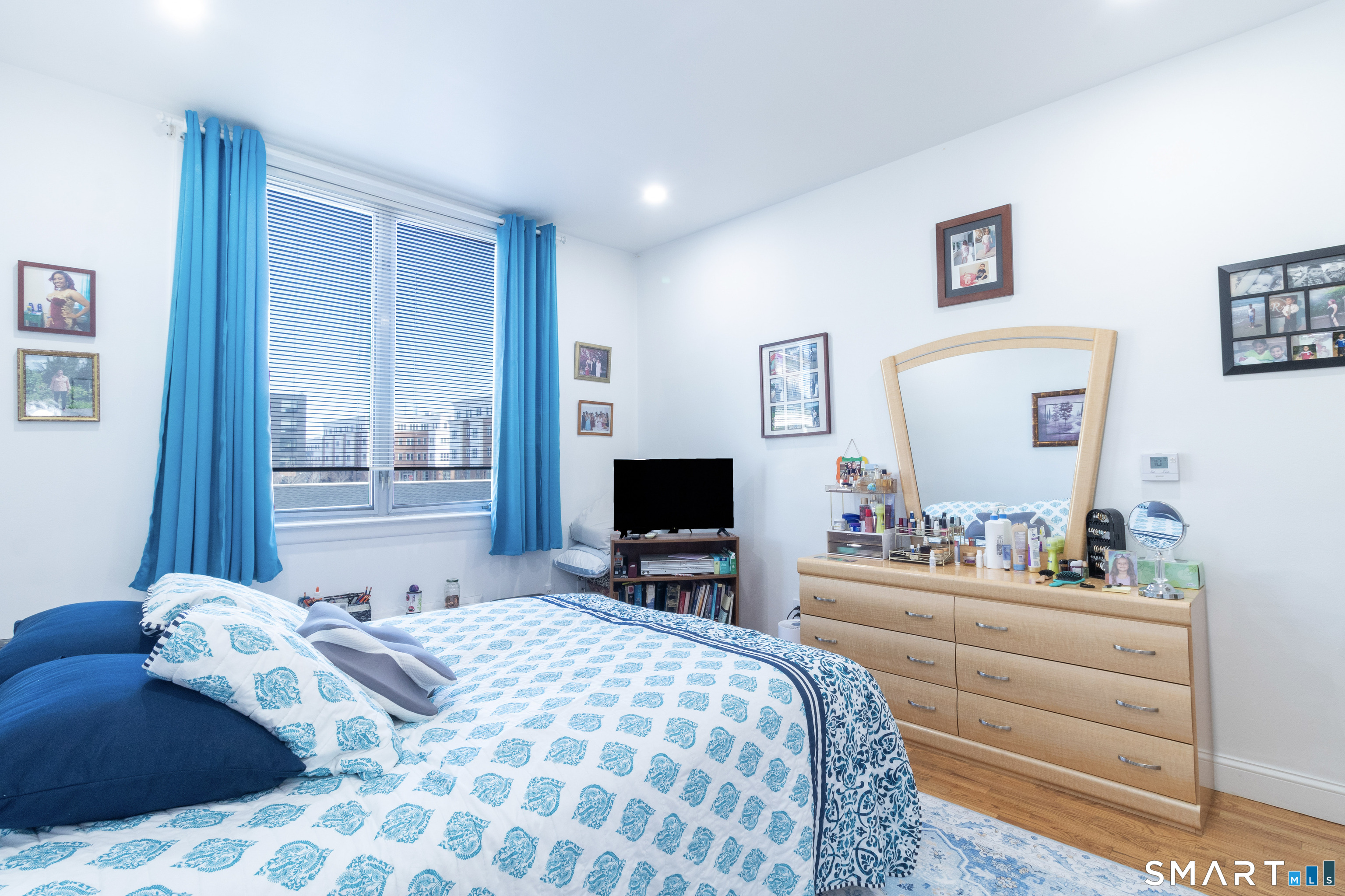 49 Day Street, Unit 209 Norwalk, CT 06854 - Photo 13 of 20 a bedroom with a bed and a flat screen tv