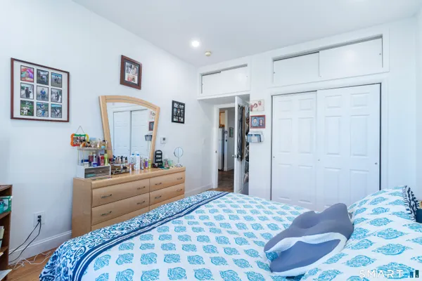 a bedroom with a bed and a dresser in it