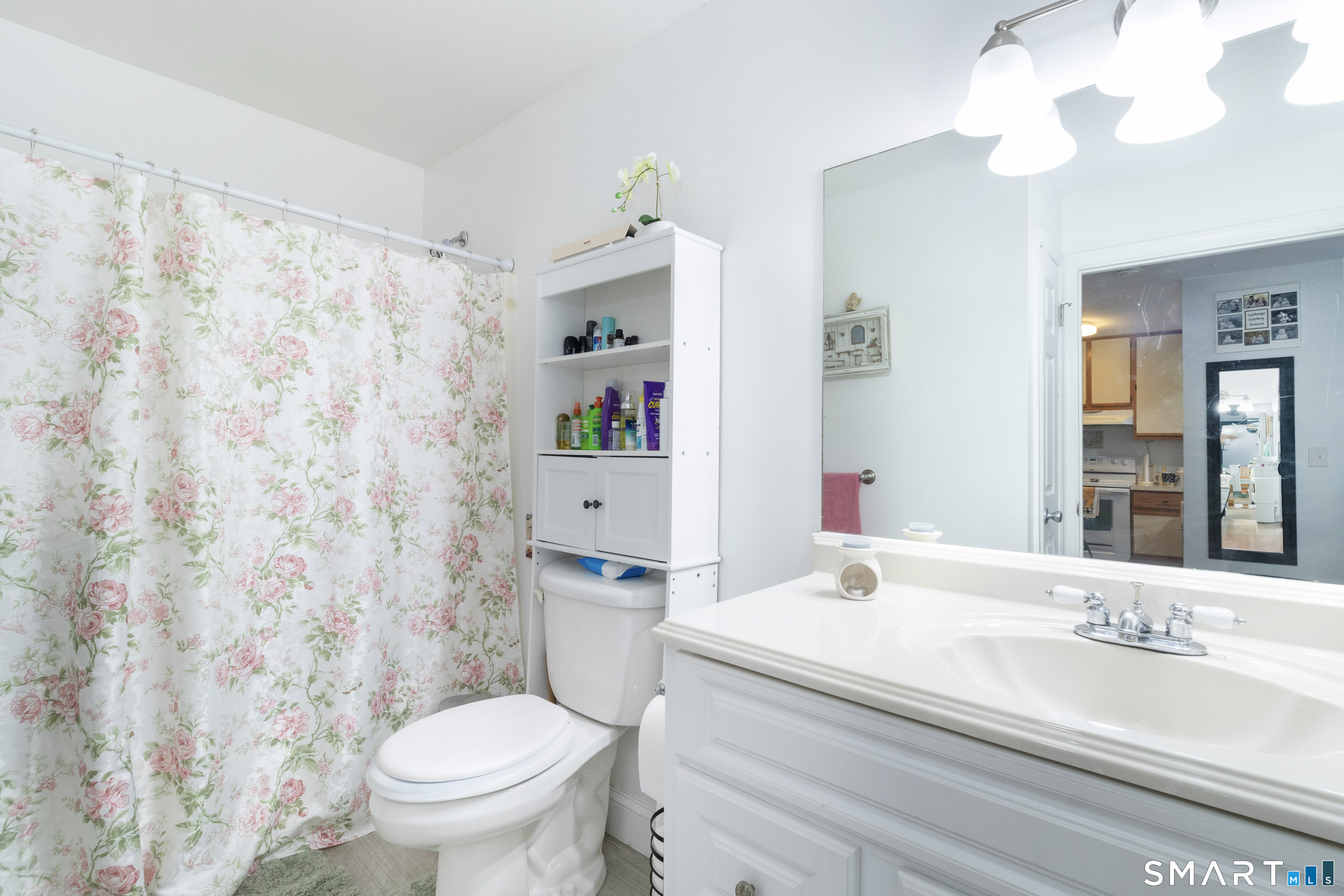 49 Day Street, Unit 209 Norwalk, CT 06854 - Photo 15 of 20 a bathroom with a granite countertop toilet a sink and a mirror