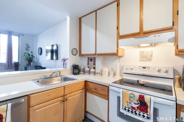a kitchen with a sink stove and microwave