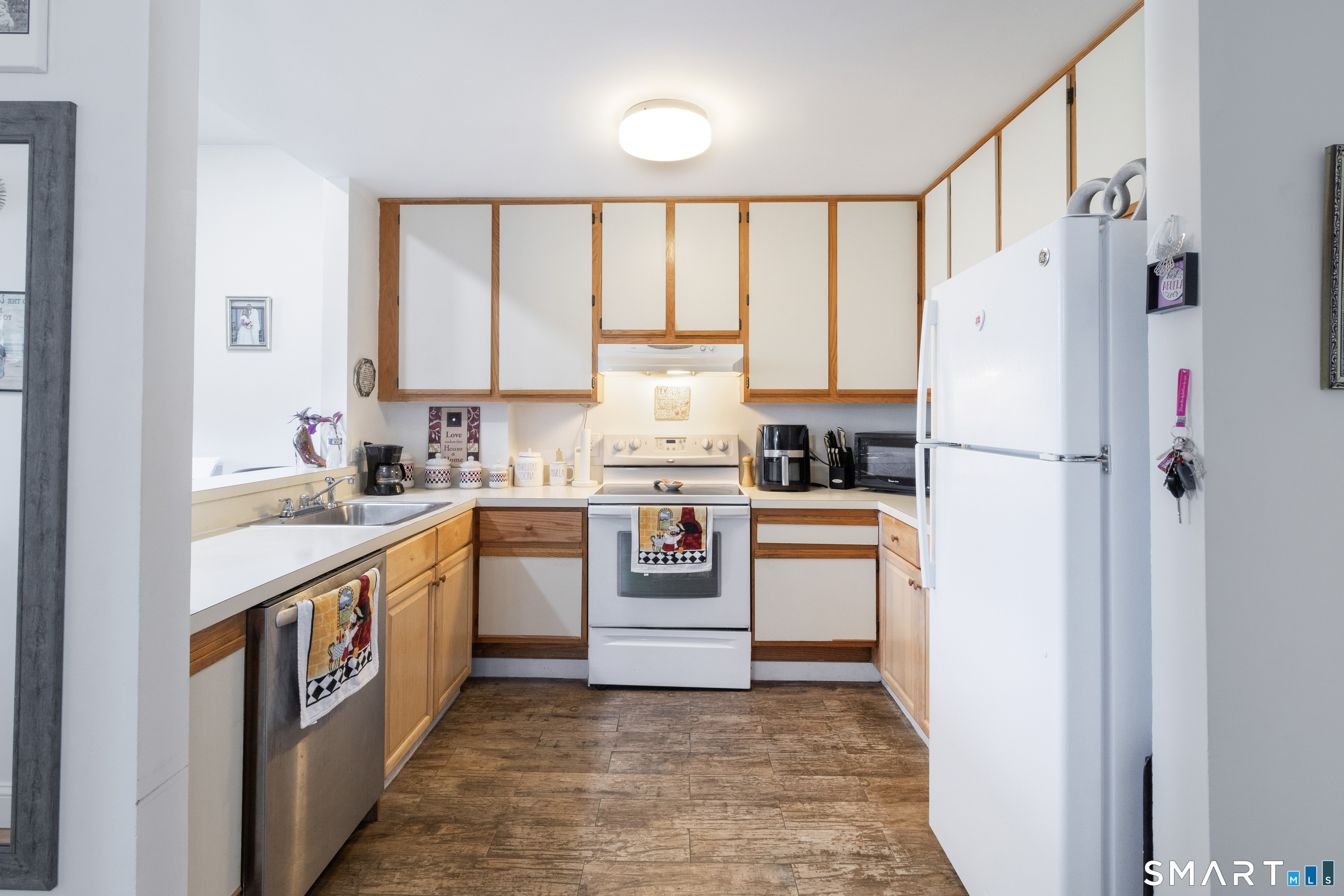 49 Day Street, Unit 209 Norwalk, CT 06854 - Photo 7 of 20 a kitchen with stainless steel appliances a refrigerator sink and cabinets