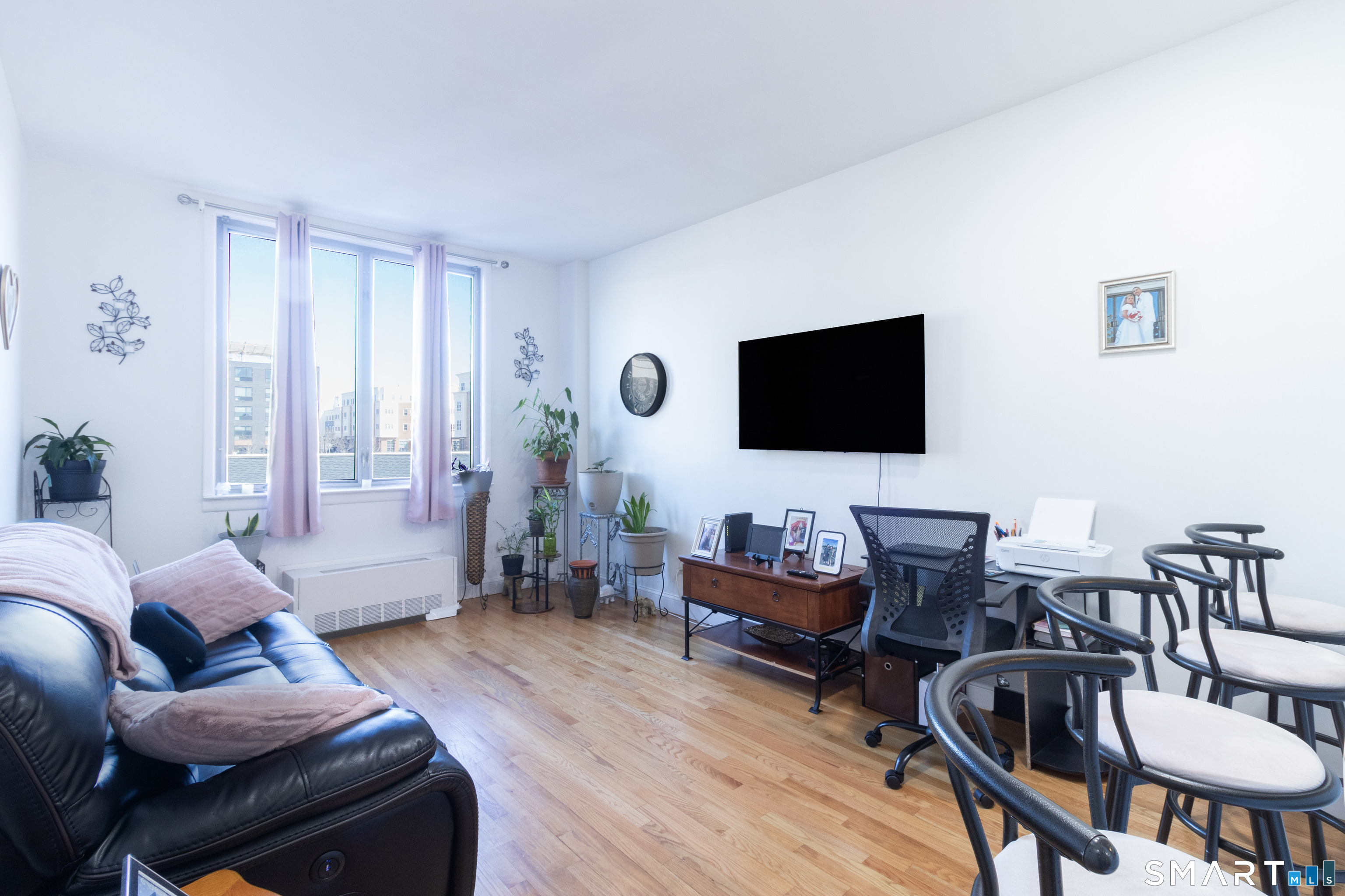 49 Day Street, Unit 209 Norwalk, CT 06854 - Photo 8 of 20 a living room with furniture and a flat screen tv