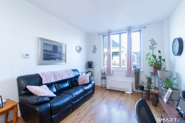 a living room with furniture and wooden floor