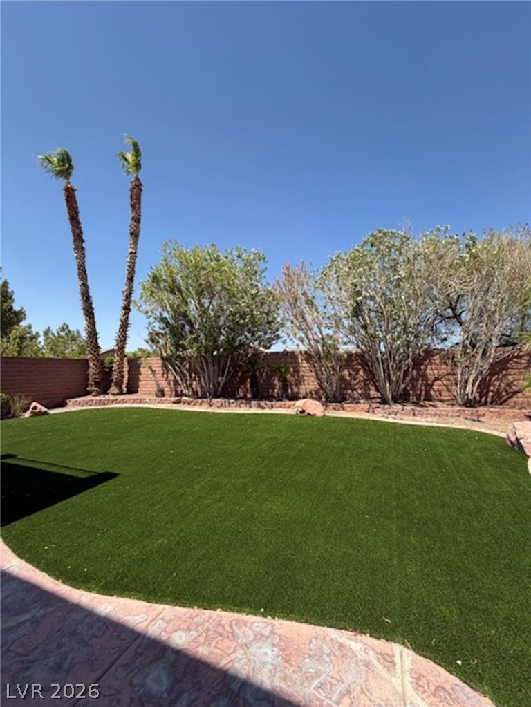 3862 Landing Ridge Place Las Vegas, NV 89135 - Photo 26 of 26 A vibrant green lawn and well-maintained landscaping create a tranquil outdoor retreat.