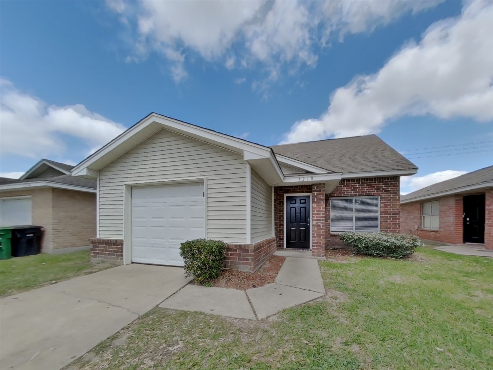 3210 Kelling Street Houston, TX 77045 - Photo 1 of 16 a front view of a house with a yard and garage