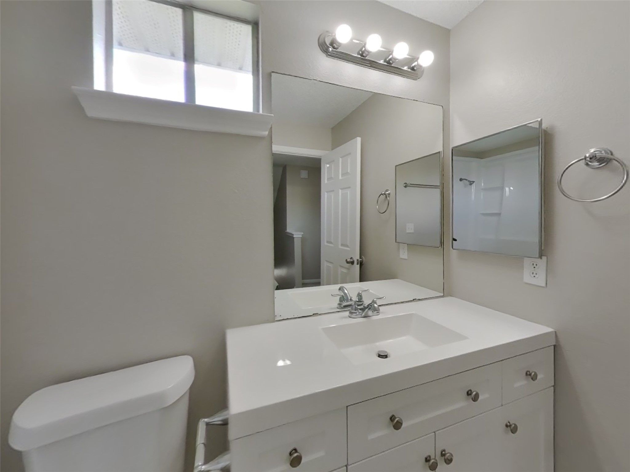 3210 Kelling Street Houston, TX 77045 - Photo 15 of 16 a bathroom with a toilet a sink a mirror and vanity