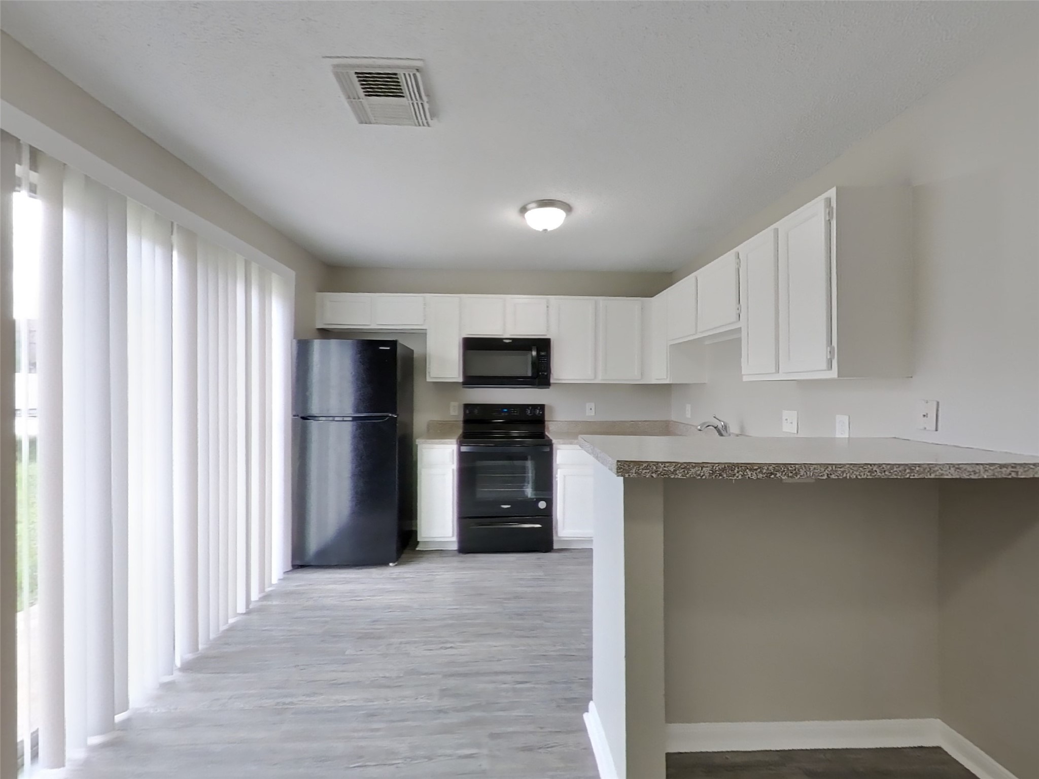 3210 Kelling Street Houston, TX 77045 - Photo 4 of 16 a kitchen with stainless steel appliances granite countertop a refrigerator and a sink