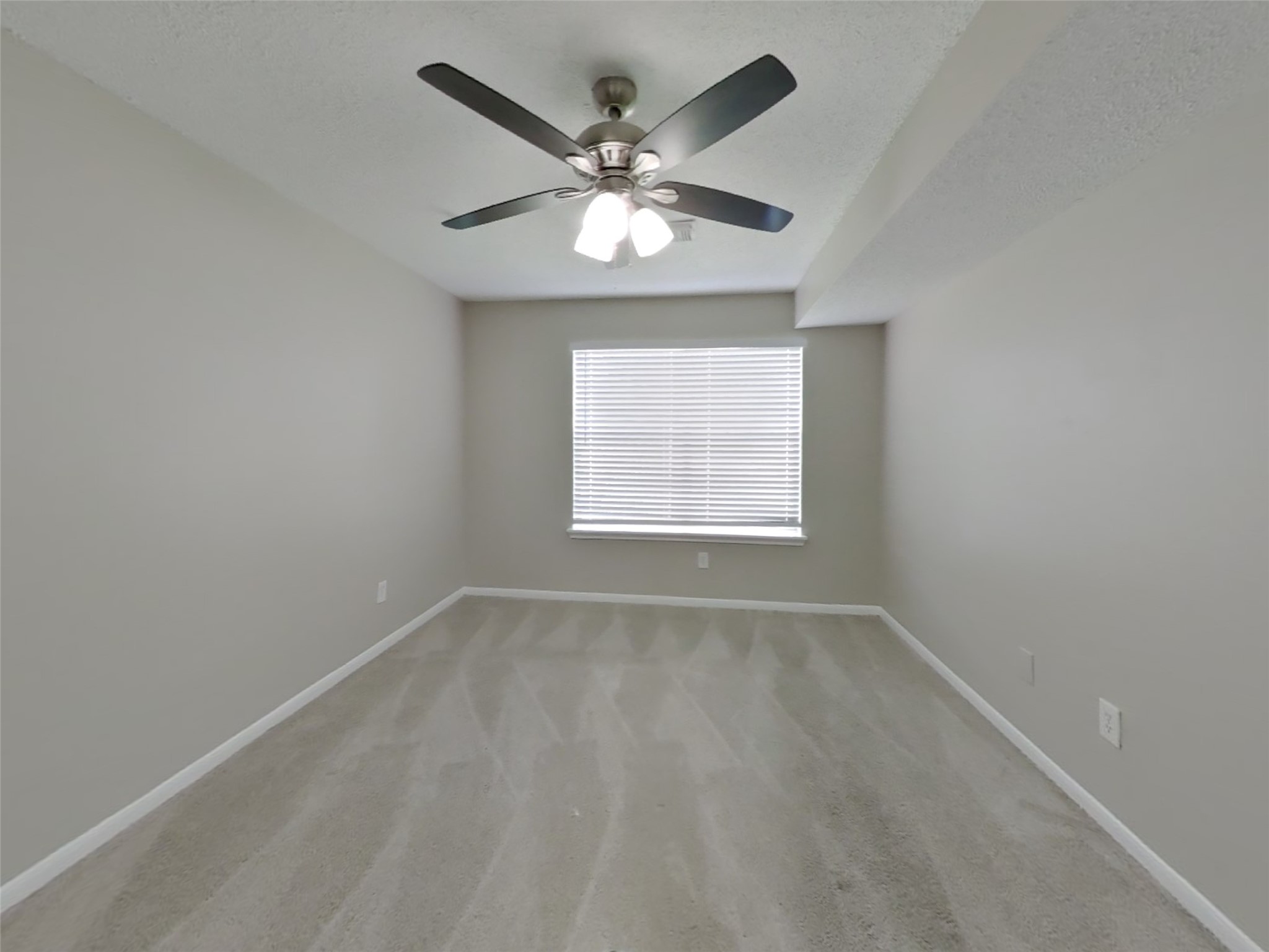 3210 Kelling Street Houston, TX 77045 - Photo 6 of 16 an empty room with wooden floor and windows