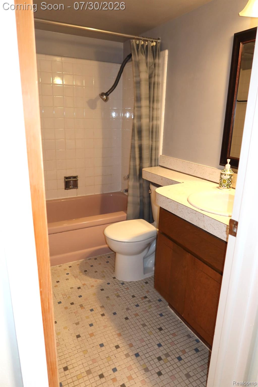 29232 Hoover Road, Unit 232 Warren, MI 48093 - Photo 7 of 22 Bathroom featuring a tile floor, built-in vanity with integrated sink, and full bathtub with shower