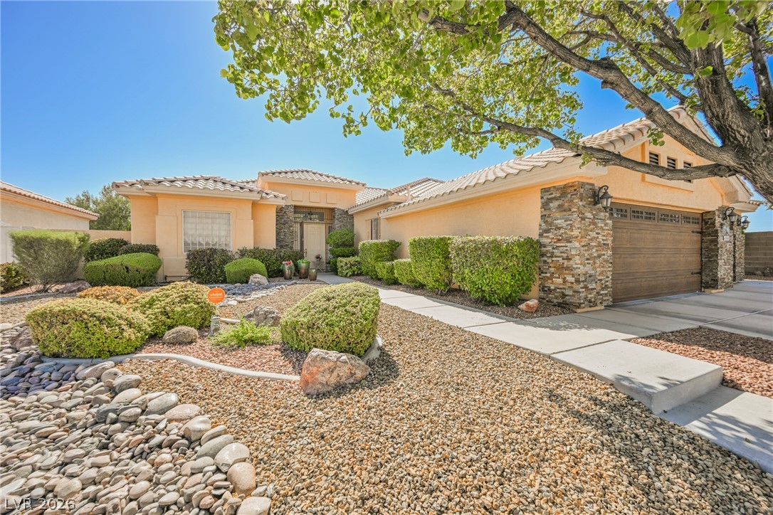 5494 Pine Ranch Street Las Vegas, NV 89113 - Photo 6 of 54 A desert-inspired front yard offers low-maintenance landscaping and an inviting entrance.