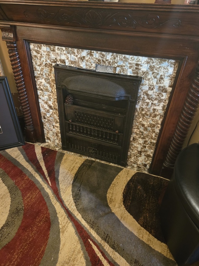 6738 South Normal Boulevard Chicago, IL 60621 - Photo 2 of 12 a view of fireplace and wooden floor