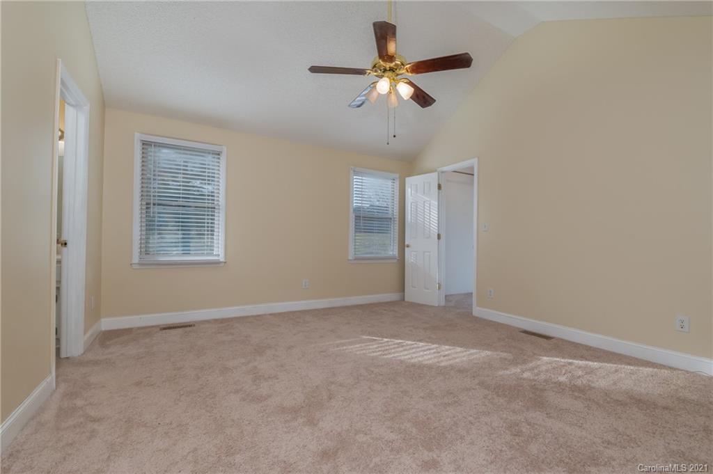 215 Orchard Grove Road, Unit 22 Campobello, SC 29322 - Photo 21 of 35 an empty room with a empty space and a ceiling fan
