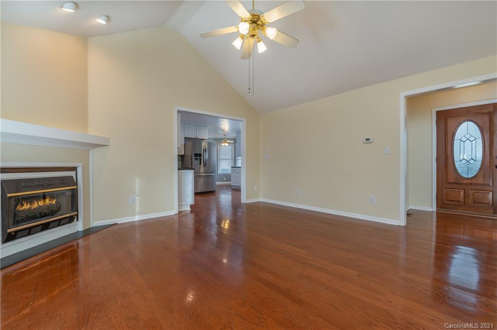 215 Orchard Grove Road, Unit 22 Campobello, SC 29322 - Photo 10 of 35 a view of an empty room with wooden floor fireplace and a window