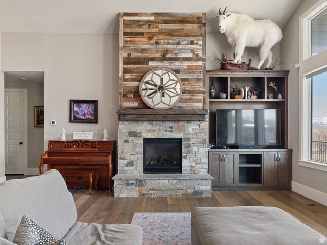 641 West 500 South Midway, UT 84049 - Photo 11 of 52 Central fireplace featuring a stone surround and wood-finish mantle