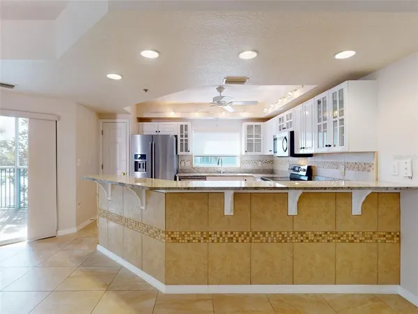 a kitchen with a sink window and cabinets